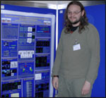 Joint poster prize winner Rainer Waadt smiling and standing next to the winning poster hung up.
