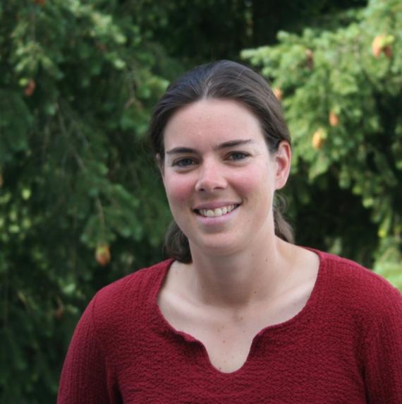 Aurélie Deveau wearing a red top stood in front of trees