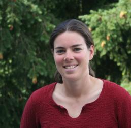 Aurélie Deveau wearing a red top stood in front of trees