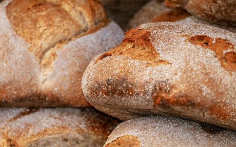 A pile of rustic round loaves of bread
