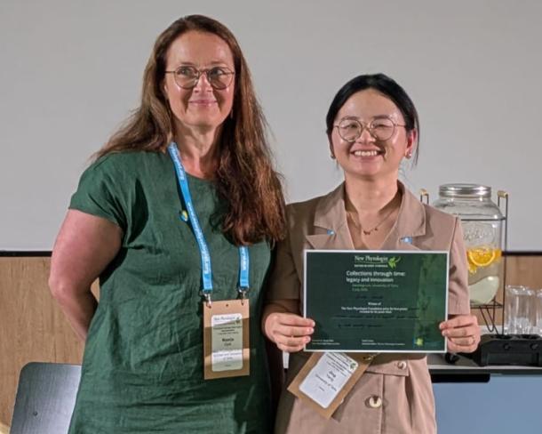 Maarja Öpik and Jing Yang. Jing holds a certificate identifying her as the recipient of the runner up poster prize.