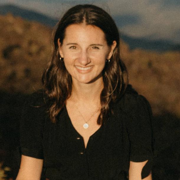 Ellen Quinlan standing in a landscape lit by golden sunlight.