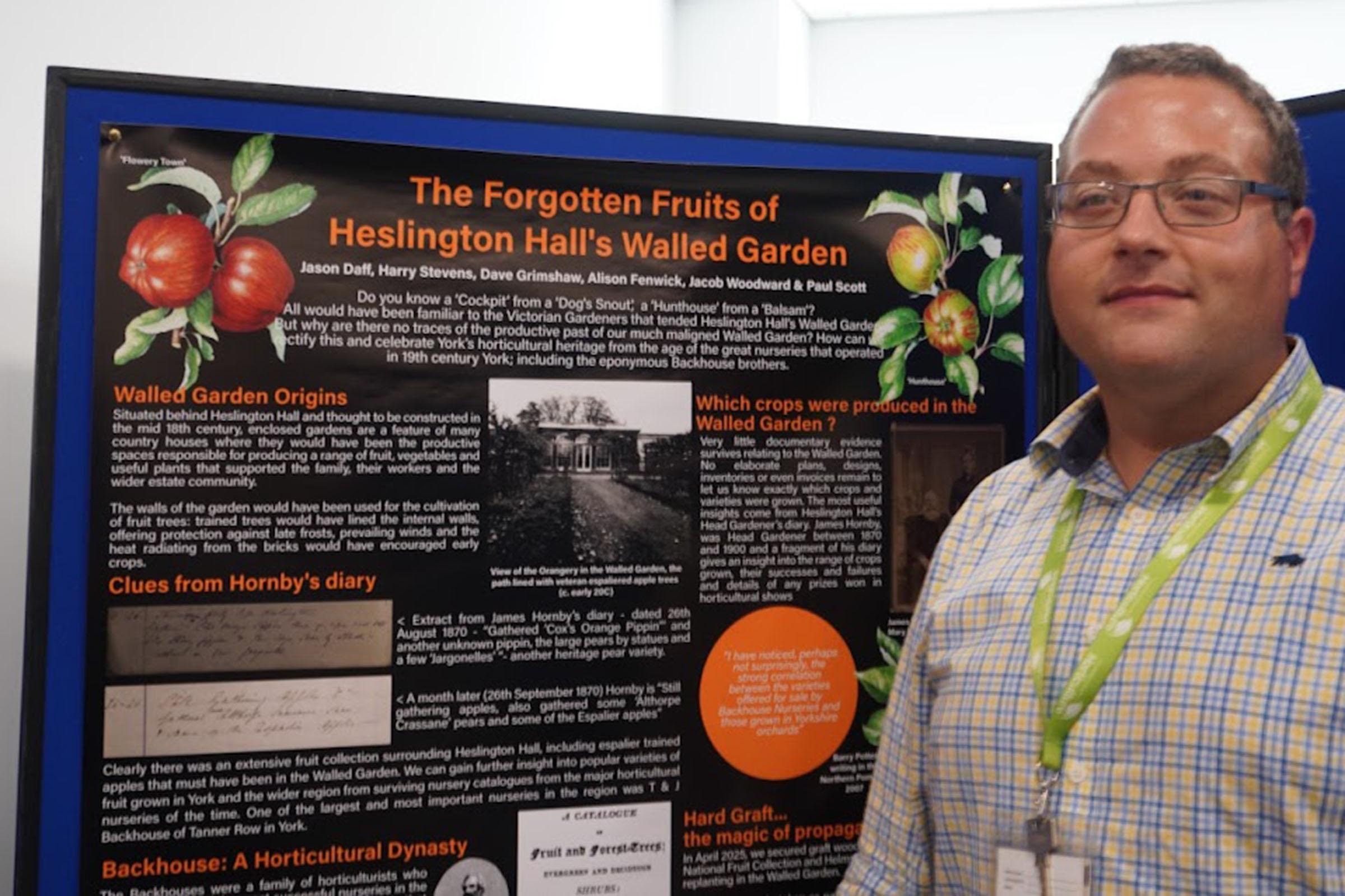 Jason Daff standing next to his poster