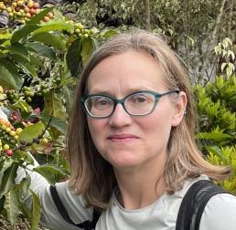 Lara Kueppers with a backdrop of various foliage and berries