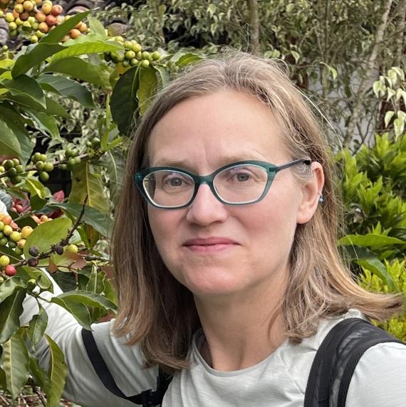 Lara Kueppers with a backdrop of various foliage and berries