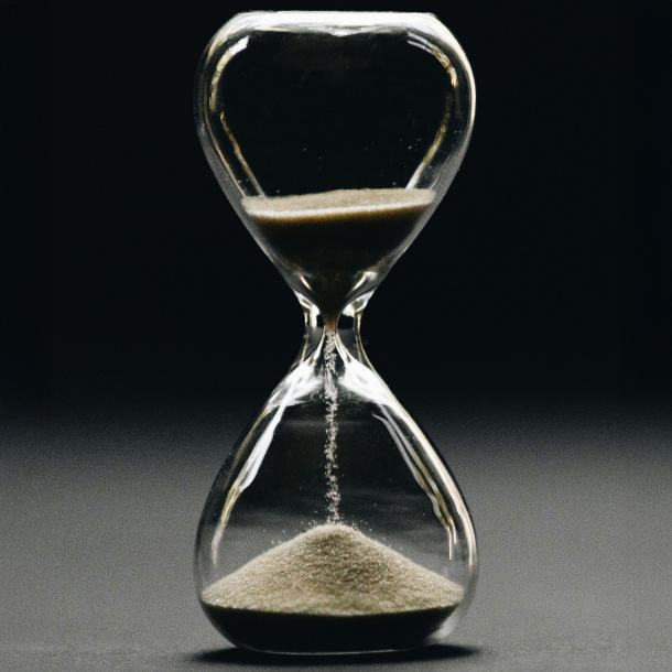 An hourglass, with sand running through it.