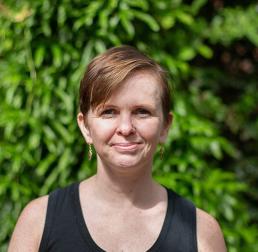 Karolina Heyduk wearing a black top in front of a leafy background