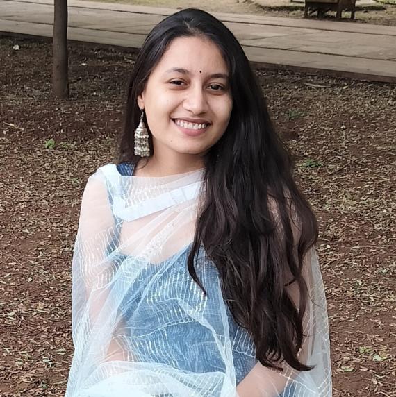 Drishti kataria sat down outdoors, smiling