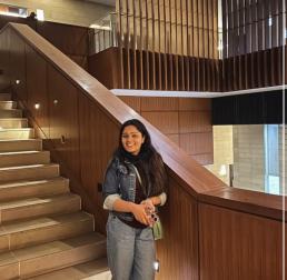 Surbhi	Phulia standing at the bottom of a set of stairs